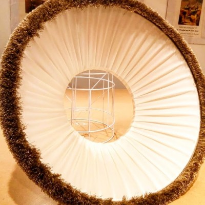 The pleated lining of a re-covered lampshade
